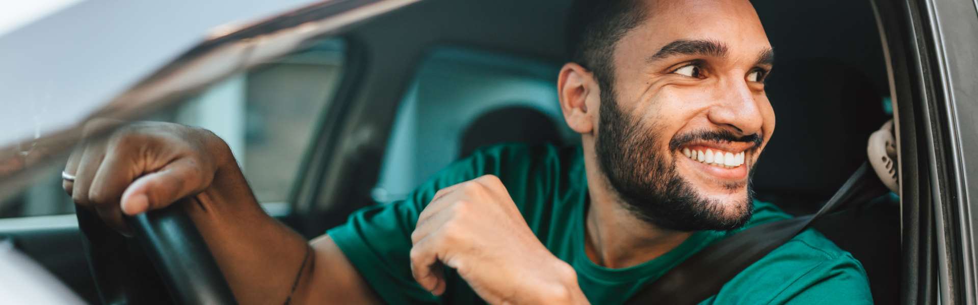 Man looking out the window of his vehicle