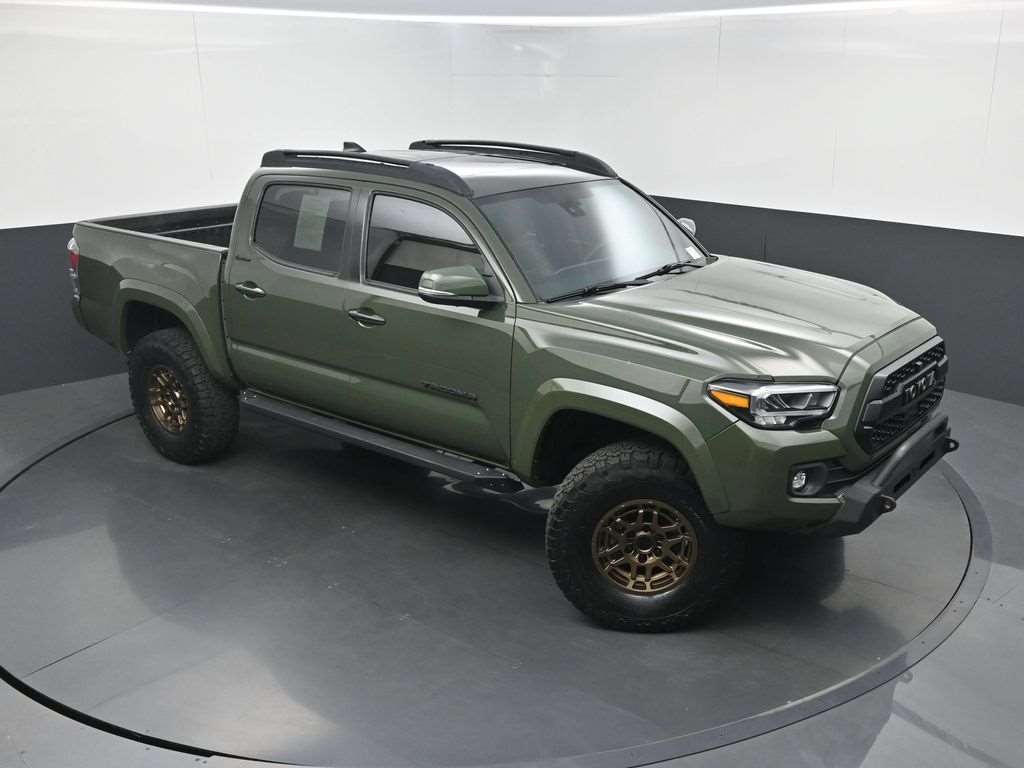 Used 2021 Toyota Tacoma front three-quarter view showing the heritage grille and bronze wheels