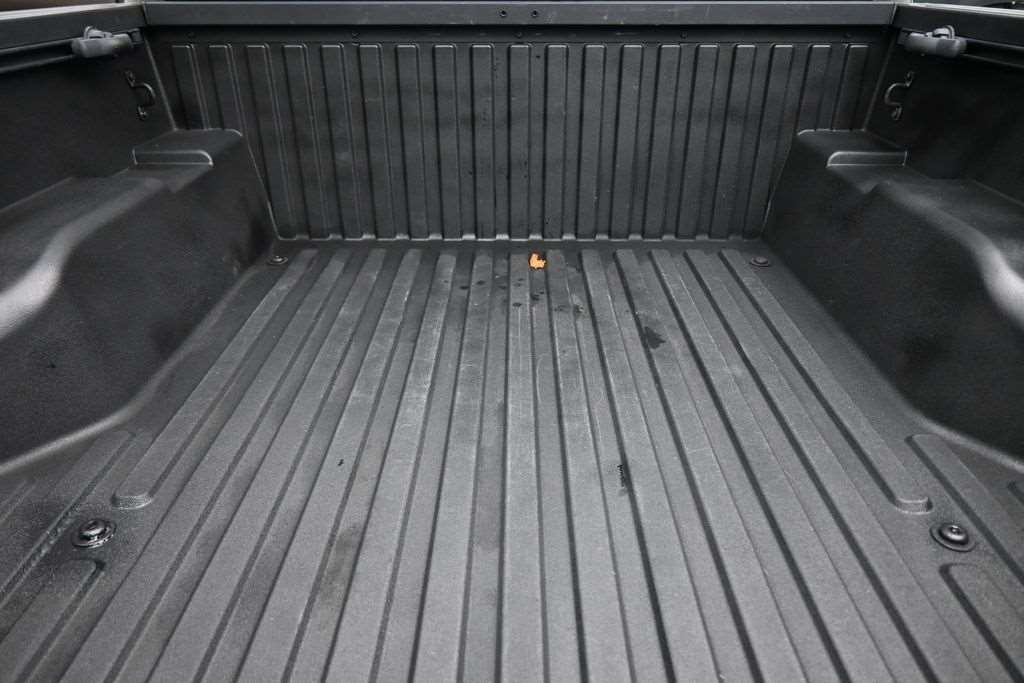 Cargo bed of a used 2021 Toyota Tacoma with bed liner