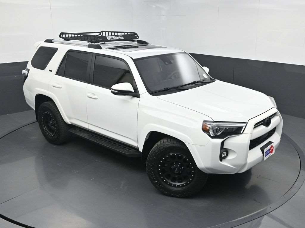 Used 2022 Toyota 4Runner TRD in white with roof rack, front three-quarter view