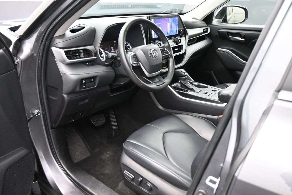 Interior cabin and dashboard of a 2023 Toyota Highlander XLE, an example of the fourth-generation Highlander interior