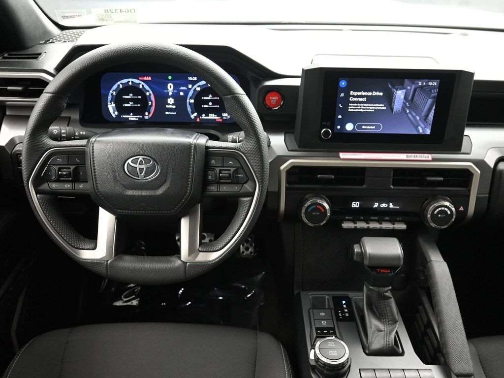 Cockpit of a used 2024 Toyota Tacoma showing the digital gauge cluster and touchscreen