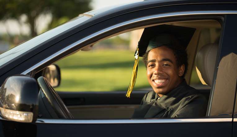 college graduate in car
