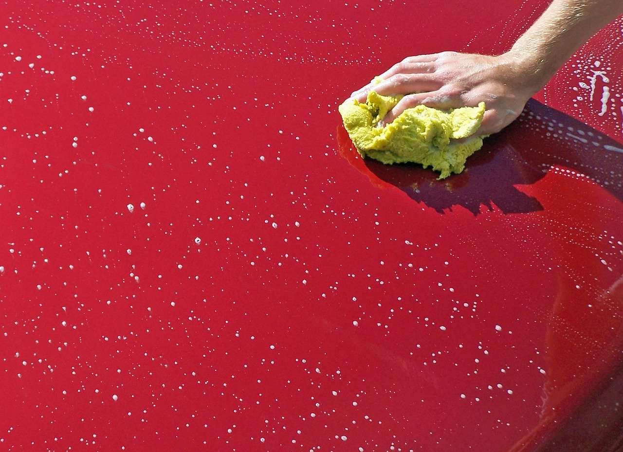 Cleaning a car with a cloth.
