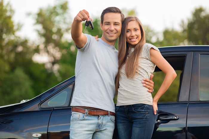 couple buying a new car