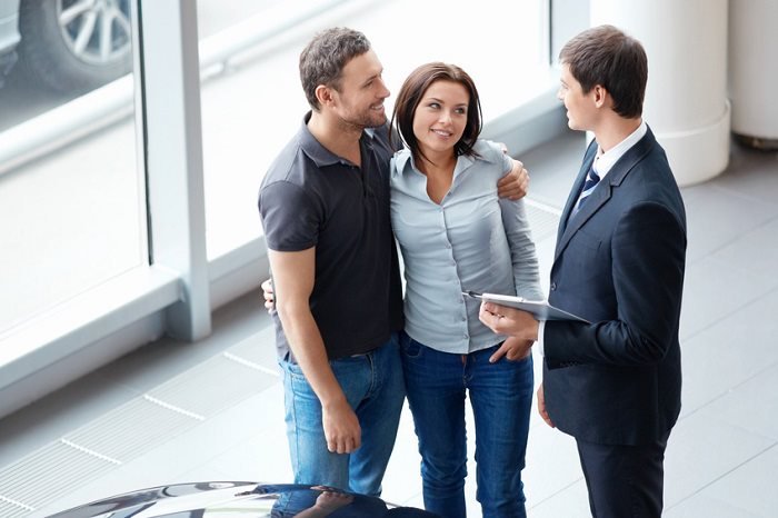 couple asking questions about used cars